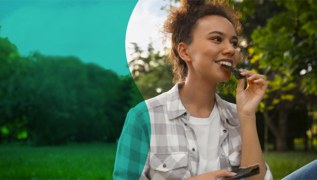 Woman enjoying healthy eating as part of a balanced lifestyle and positive relationship with food.