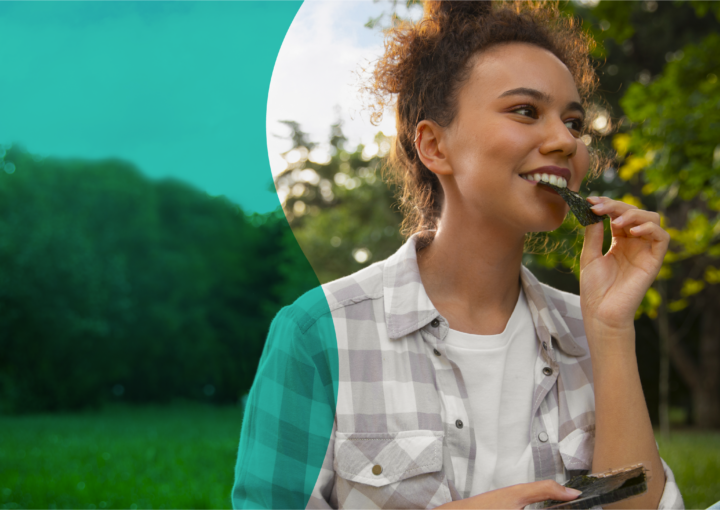 Woman enjoying healthy eating as part of a balanced lifestyle and positive relationship with food.